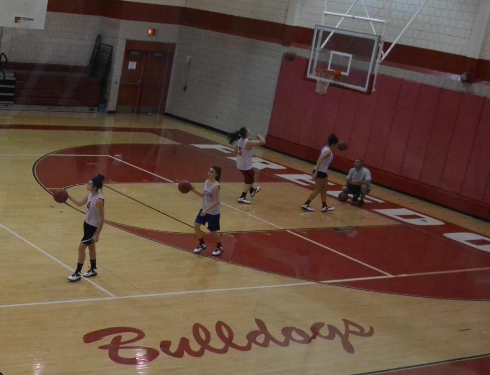 The girls dribble down the gym floor during practice at an open gym workout.