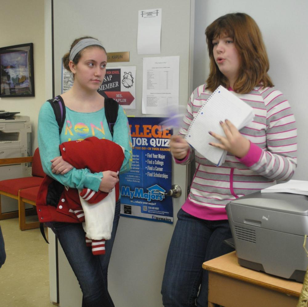 Junior Amanda Herzog instructs Sevice Club Member Junior Carley Schroeder on their latest service project: Teens for Jeans.