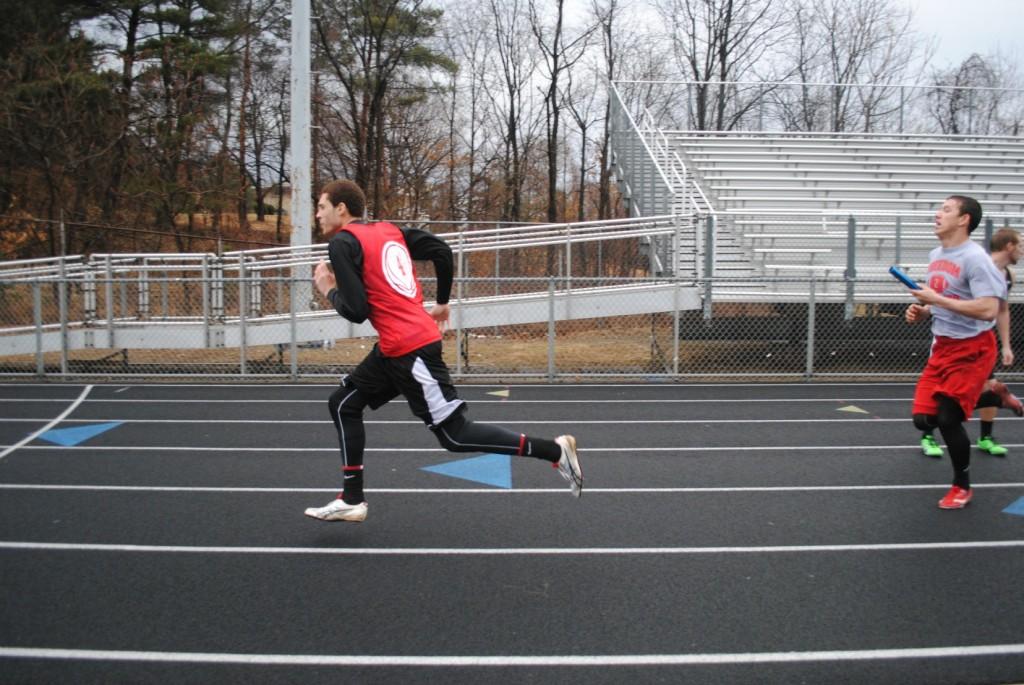 Junior Brenton Harrison (left) runs ahead of Senior Jared Hogue (right) to prepare for their hand-off  during the 4 x 100 meter relay in a scrimmage against South Side and Central Valley on March 19.