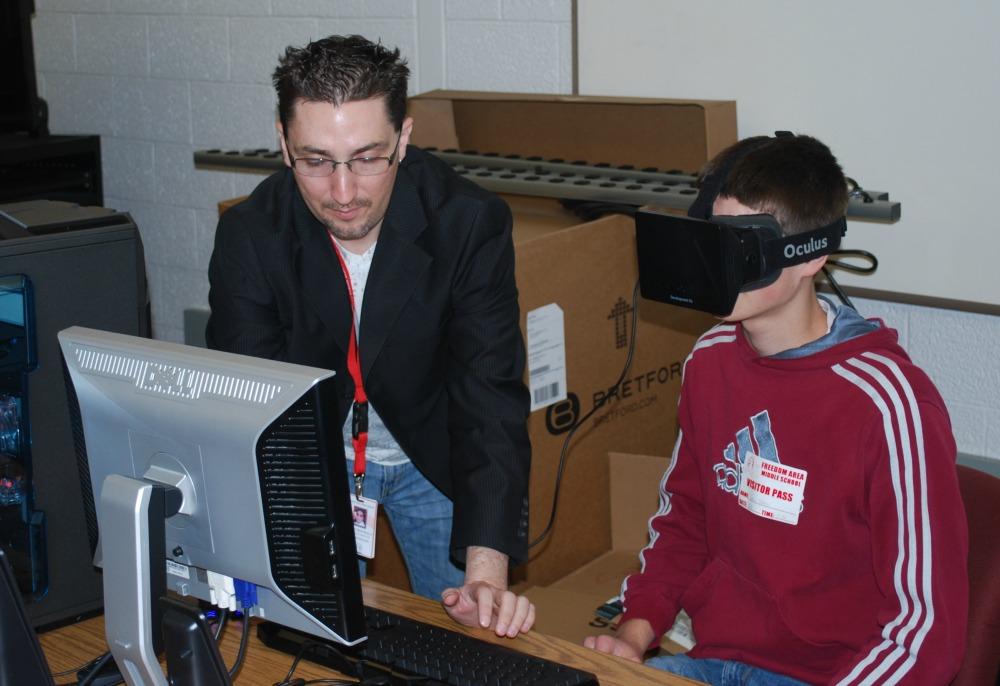 Mr.+Matt+Scala+and+Sophomore+Louis+Dubovi+testing+the+Oculus+Rift+program.