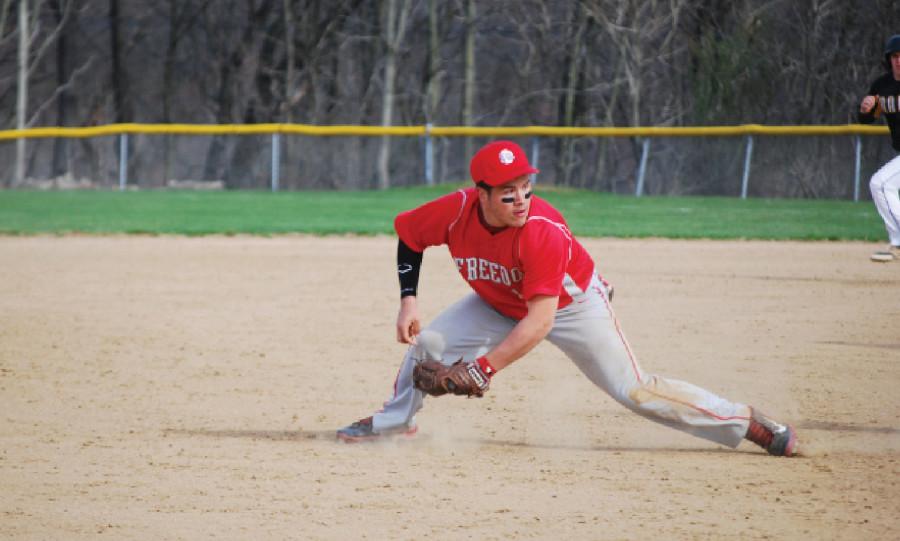 Junior Evin Dicieio fields a ball at third base during a baseball game against South Side.