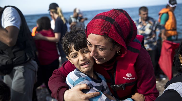A+Syrian+woman+embraces+her+child+after+they+arrived+with+others+migrants+on+a+dinghy+from+Turkey+to+Lesbos+island%2C+Greece%2C+Friday%2C+Sept.+11%2C+2015.+While+migrants+for+years+have+taken+death-defying+trips+across+the+Mediterranean+to+reach+the+relative+peace+and+comfort+of+the+Europe+Union%2C+the+flow+has+hit+record+proportions+this+year+-+notably+with+an+influx+of+Syrians%2C+Afghans+and+Eritreans+fleeing+trouble+back+home.+%28AP+Photo%2FPetros+Giannakouris%29
