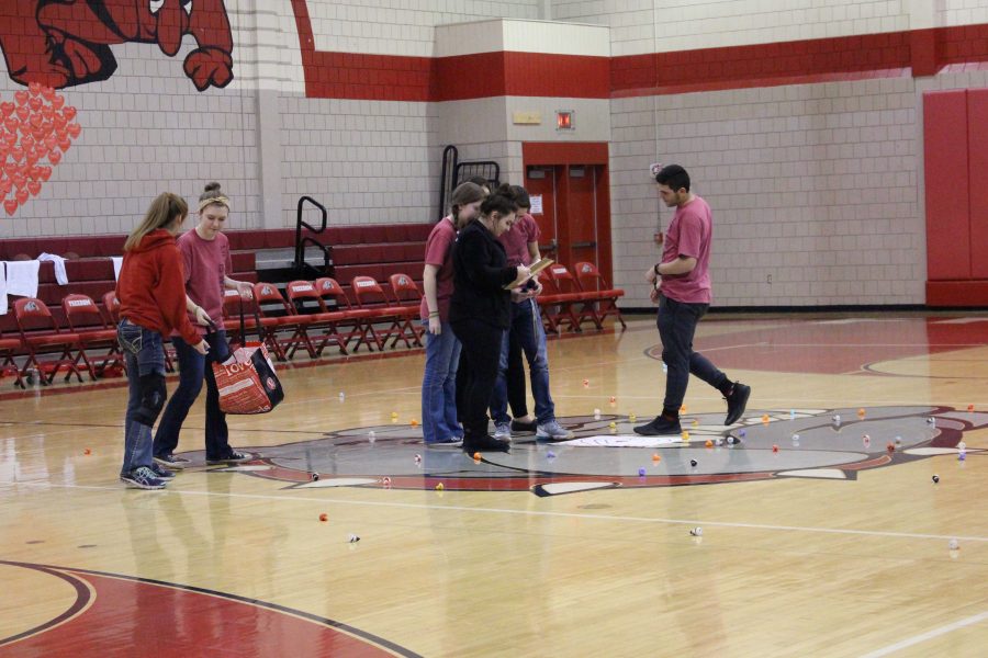 NHS members collect the ducks scattered across the court after the “chuck-a-duck” contest.
