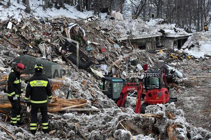  Rescuers look upon ruins of Hotel Rigopiano on Jan. 26.