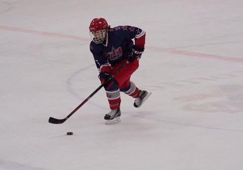 Senior Alexziz Giannamore skates the puck down the ice at a game in Canada