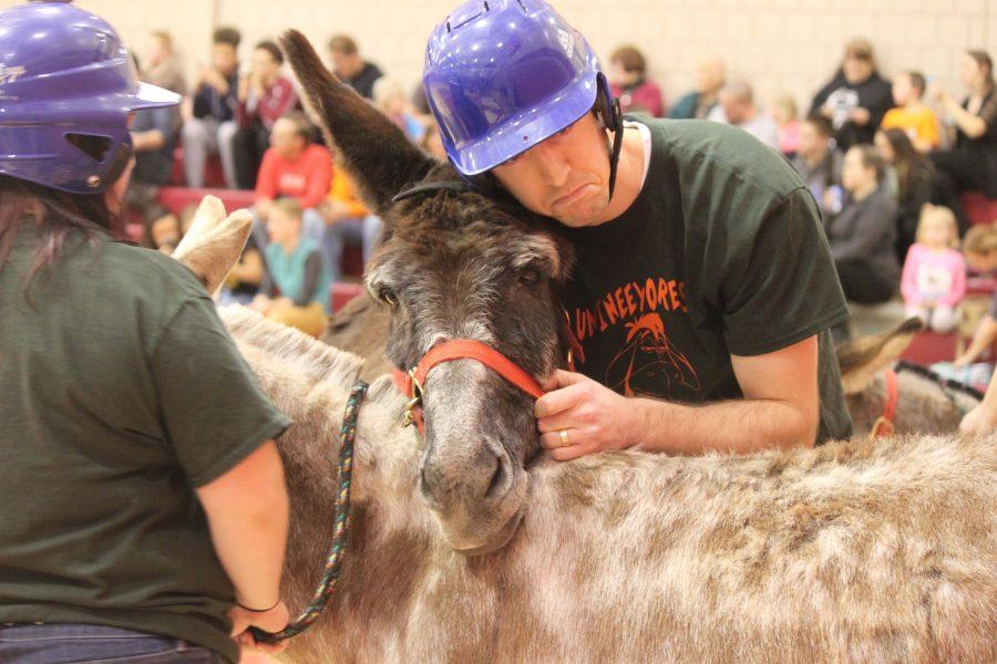 High school teacher Nate Langelli consoles his donkey after its resistance to play the game on Feb. 27 in the high school gymnasium.