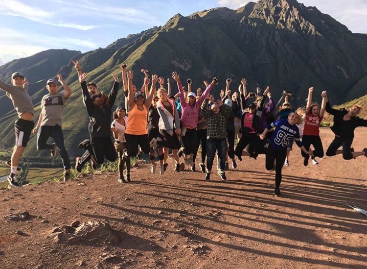 The group jumps in front of a cliff on April 15 to celebrate their hike.