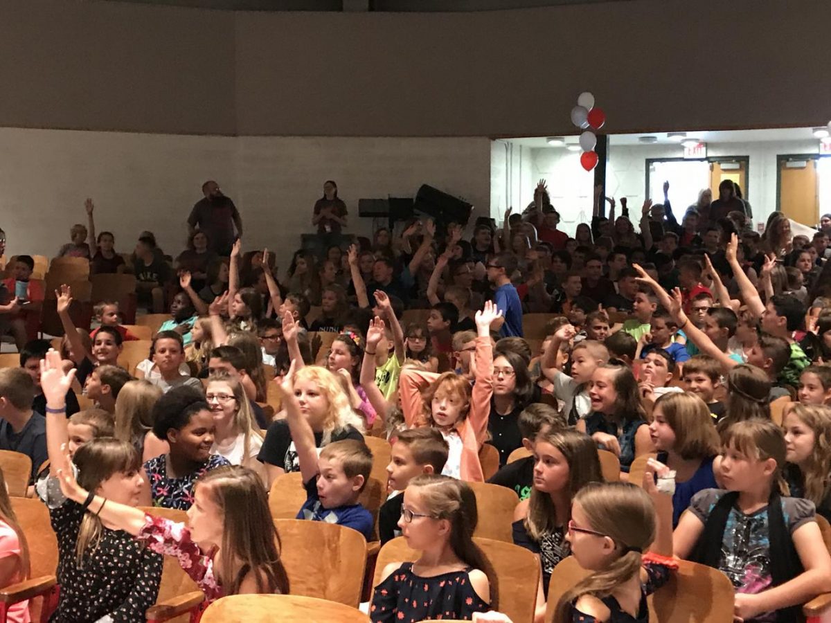 Middle school students participate in the PAWS assembly on the first day of school.