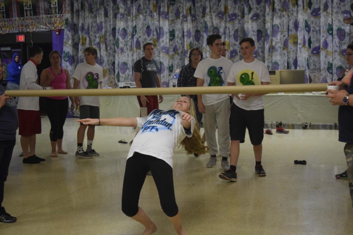 Ally Schmiedlin, along with other seniors, enjoy a game of limbo at Project Graduation.