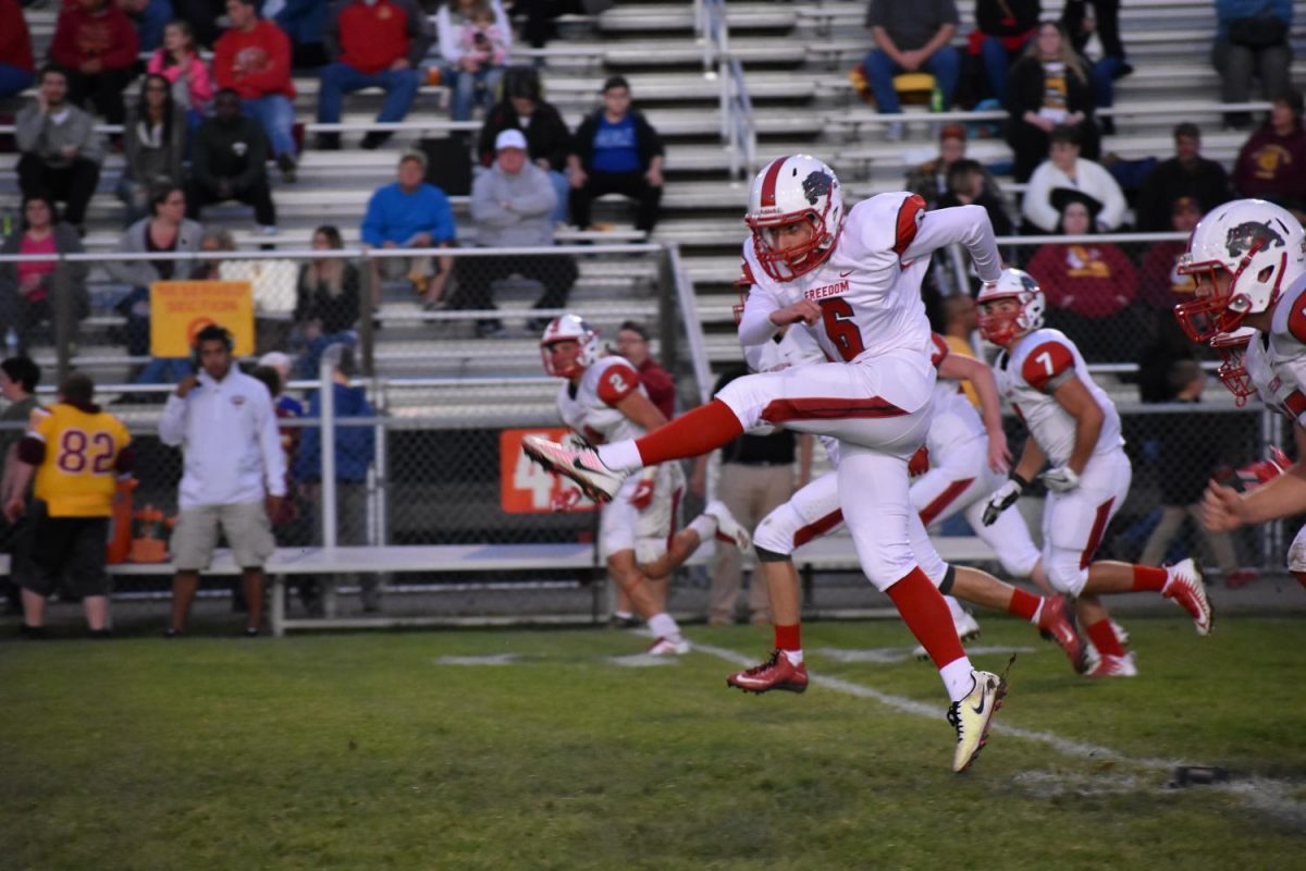  Senior Carson Gilarno kicks off for Freedom against New Brighton during the game on Sept. 8.