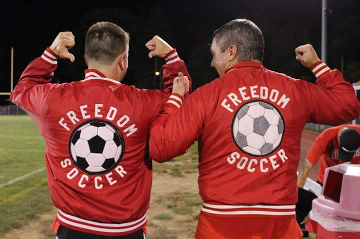 John Mohrbacher and Jon Stich stand next to each other after game with matching letterman jackets on.