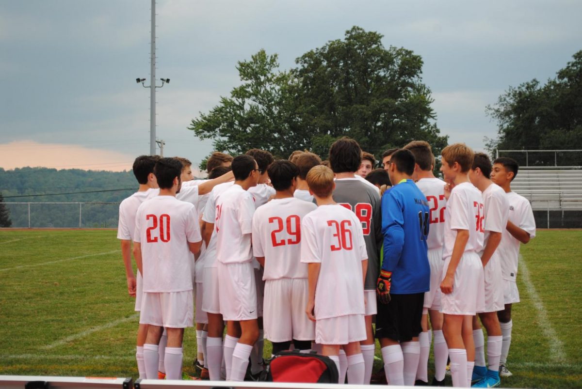 The Freedom Boys Soccer team huddles up before taking the field.