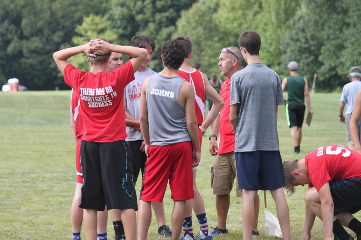 The boys ready themselves for the race as coach Ed Shephard talks to them about the course.