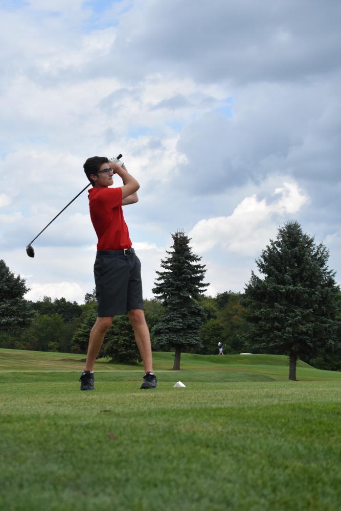 Senior Dante Colorito watches the ball after his drive.