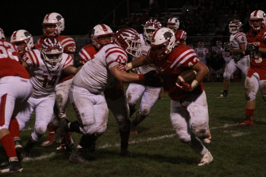 Junior Cody Ross attempts to gain rushing yards against the Mohawk Warriors. 