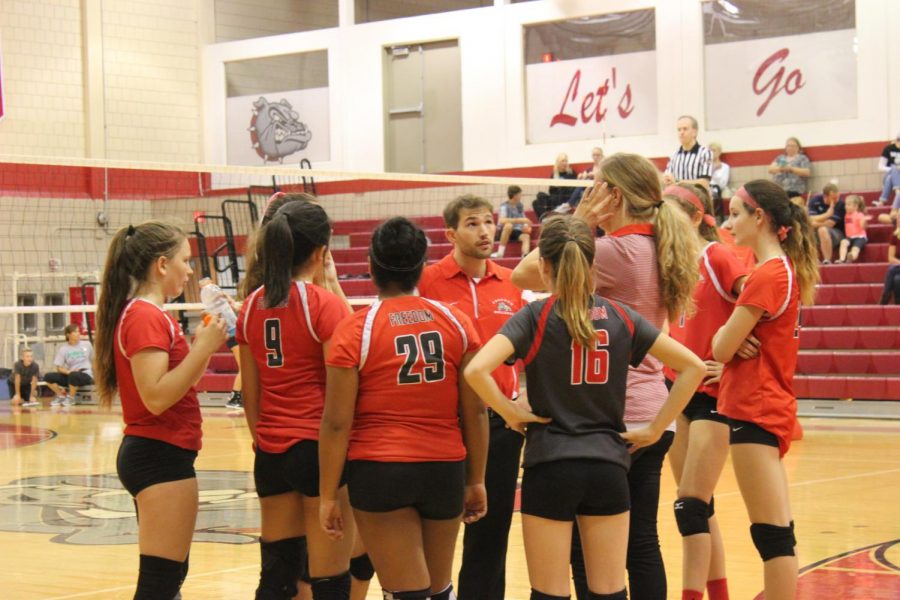 The volleyball team gathers together during their varsity game against Beaver.