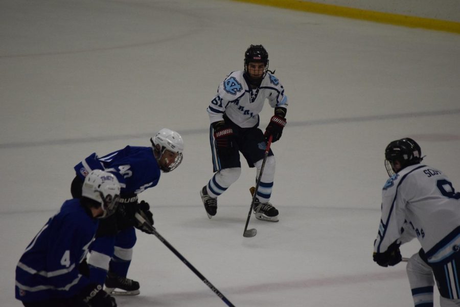 Senior James Kelly-Tindall fights towards the puck at the game on Dec. 14 against Connellsville.