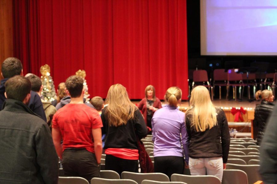 Attendees participate by standing to show how many have died from overdoses.