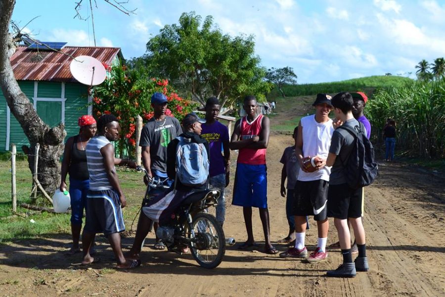  Group of Dominican people communicate with American missionaries.