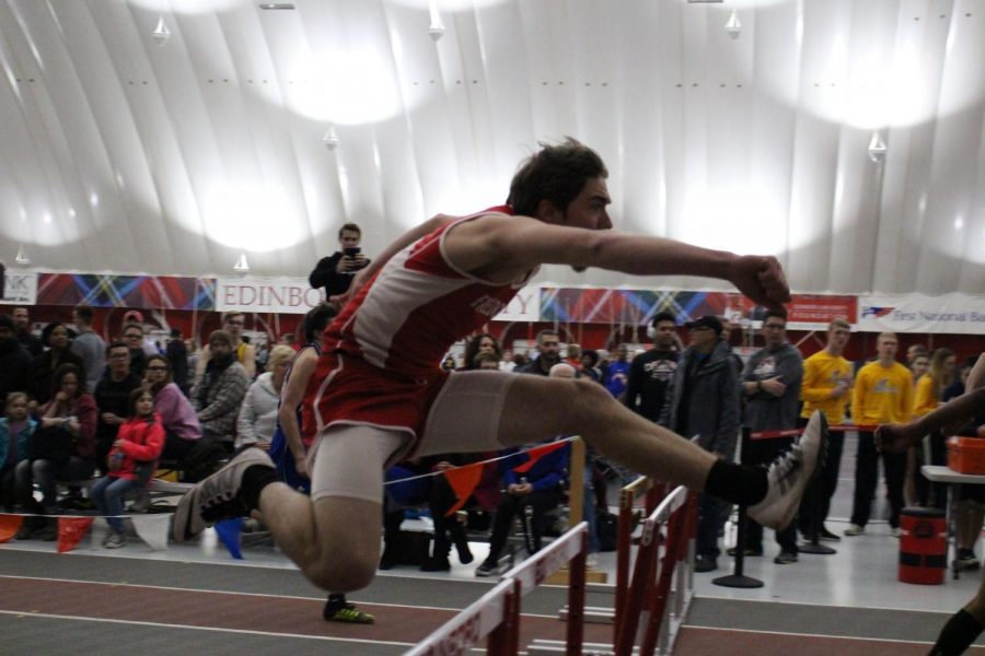 Senior Michael Keith puts a good foot forward into his hurdle at a meet.