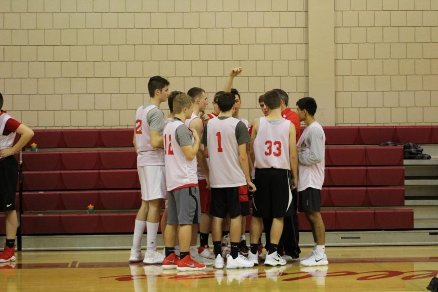 The Boys Basketball team huddles up during game against Western Beaver.