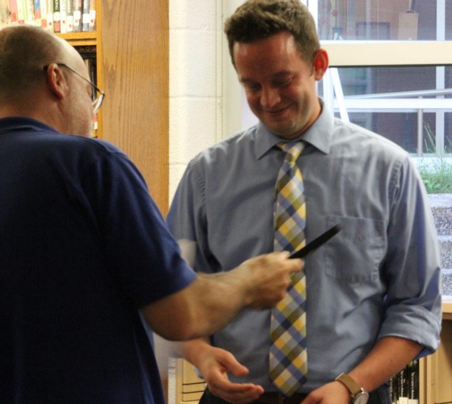 Teacher Aaron Fitzpatrick is handed his certificate for 2018 PSPA Journalism Teacher of the Year by PSPA Board President Paul Fantaski in the Middle School library during the Sept. 18 school board meeting.