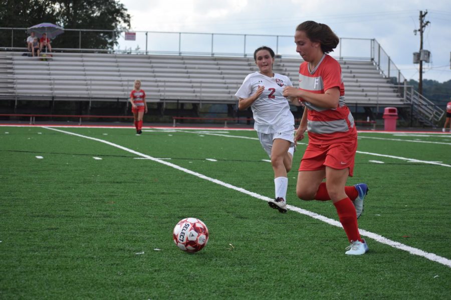 Senior Olivia Wolf charges to win over the ball on Spet. 6 during the game against Sewickley Academy. 