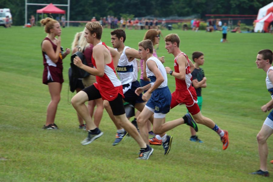 Junior Adam Hessler gains on competitors from opposing schools as he approaches the finish line. 