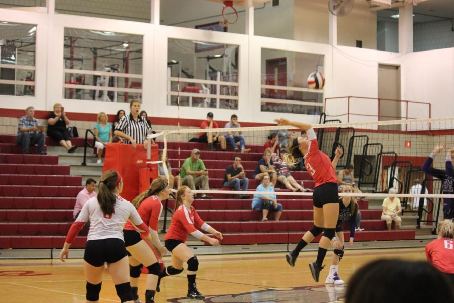 Junior Morgan Swab goes to spike the volleyball at the OLSH varsity volleyball team. 