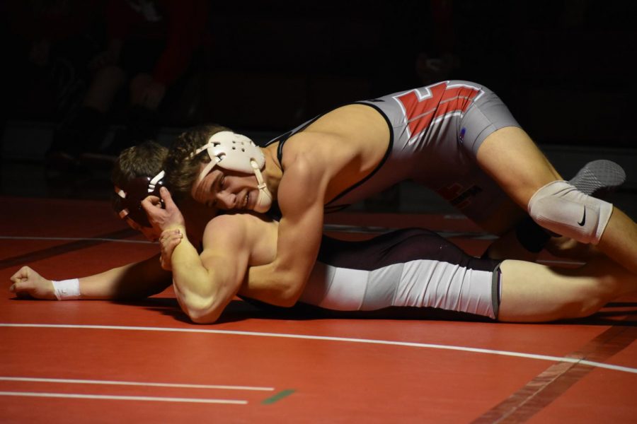 Senior Jake Pail attempts to pin his opponent during a match against Beaver on Dec. 20, 2017.