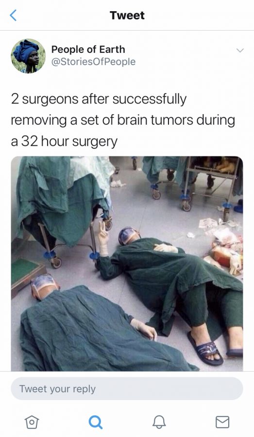 Tweet shared by @StoriesOfPeople of two surgeons laying exhausted after 32 hour surgery. 