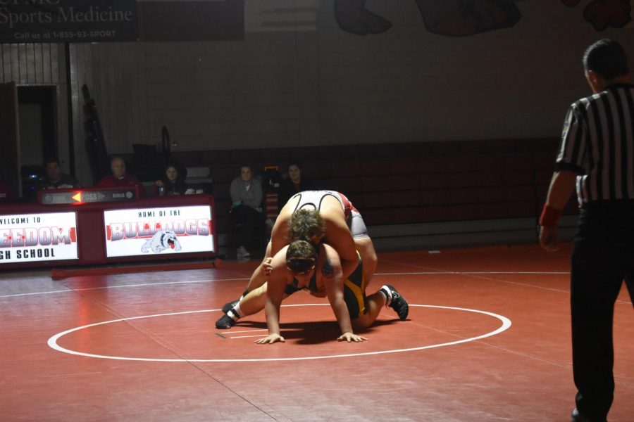 During the home match against Blackhawk High School on Dec. 12, Nando Franco attempts to hold down his opponent to contribute more points to Freedom’s score.