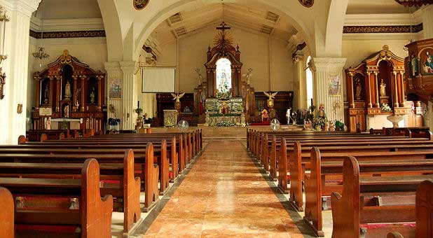 The bare view of an empty church altar and the pews prior to a service.