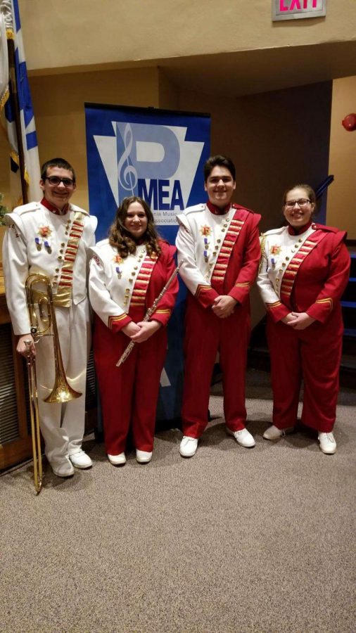 Juniors Cole Skuse and Mason Hedge, sophomore Marissa Lammie and senior Mikayla Evans pose for photo prior to their concert at Honors Band on Dec. 1.