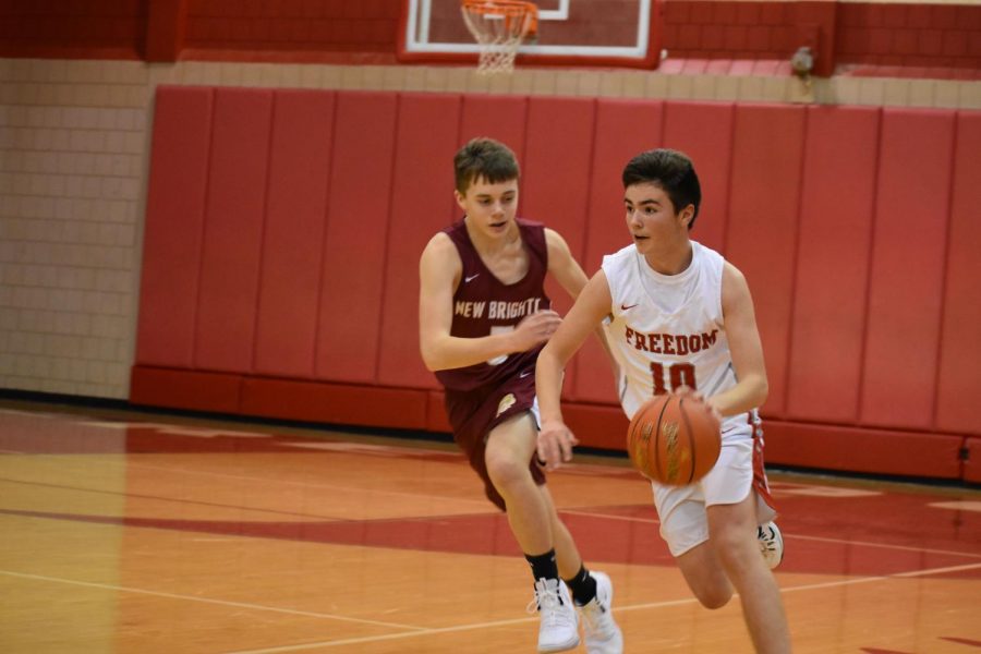 Freshman Carter Slowinski dribbles down the court, attempting to outrun an opposing player at the game against Western Beaver on Dec. 11.