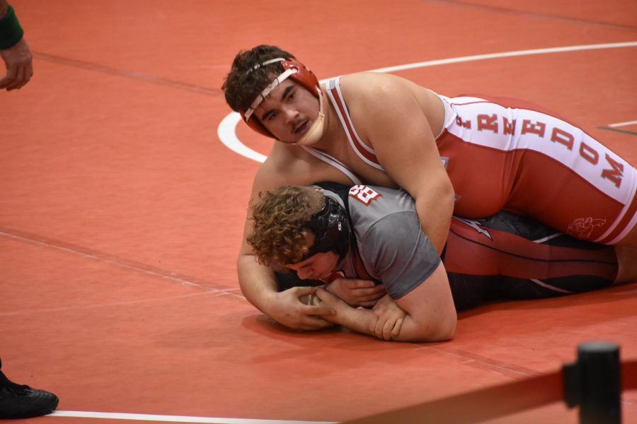 Looking to Coach Jim Covert, junior Fernando Franco seeks advice on how to earn more points during his match on Jan. 5 during the MAC tournament.