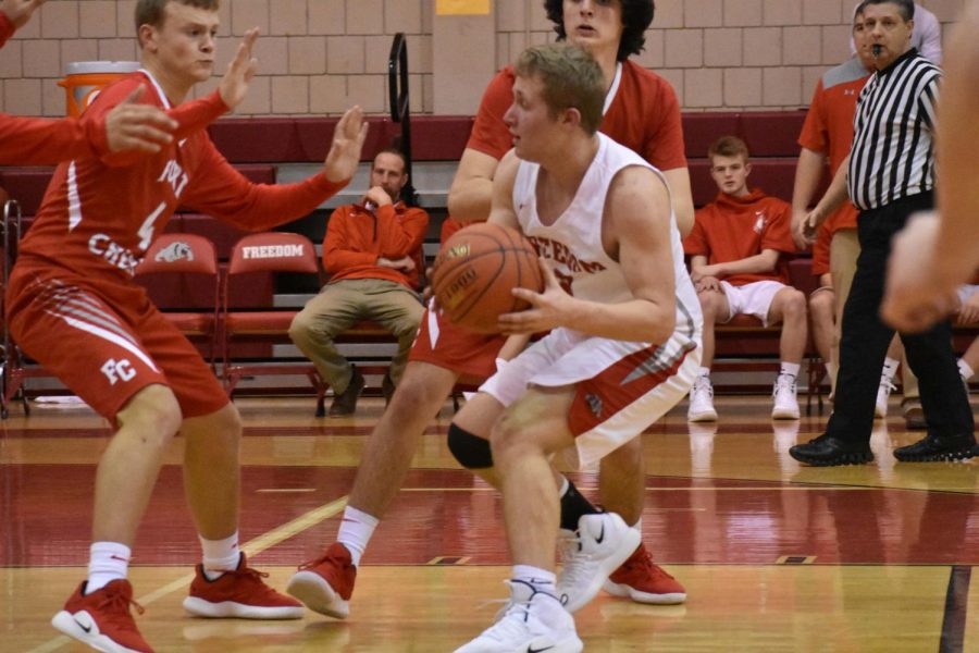 Junior Tyler Borgman defends the ball while surrounded by competitors from Fort
Cherry on Jan. 24.