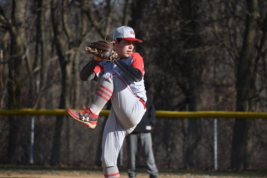 Junior Jacob Bauman is one of many
returning players from last year. Above
as a sophomore, Bauman is seen gearing
up for a pitch during the Bulldogs game
against Summit Academy on March 13.