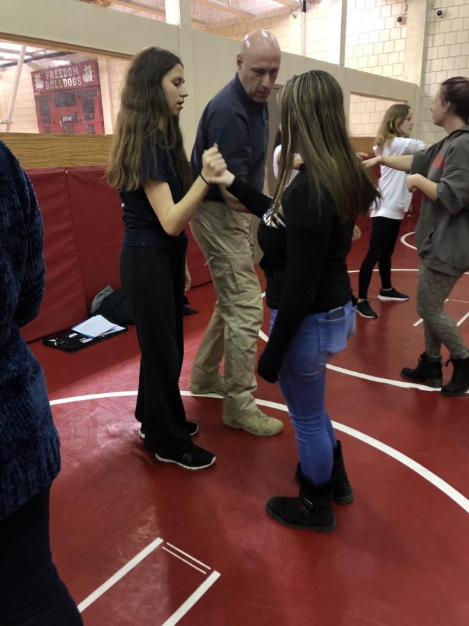 Deputy Shane teaches freshman Grace Shane and sophomore Ella Nicely different techniques they may use to defend themselves, in any type of emergency that can cause them physical harm. 