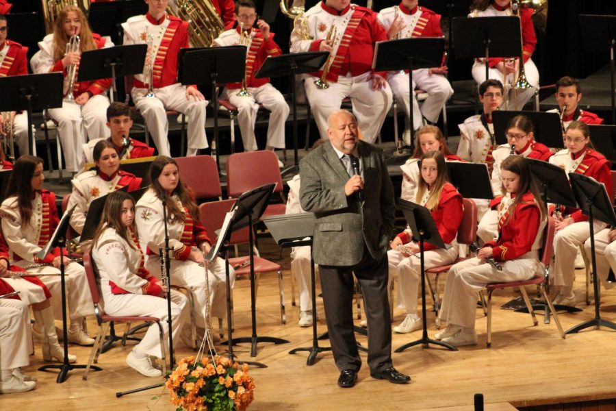 Band Director Keith Kovalic enlightens the crowd on his musical choices for the night. He pointed his mother out in the audience and explained the influence she had on his first song.