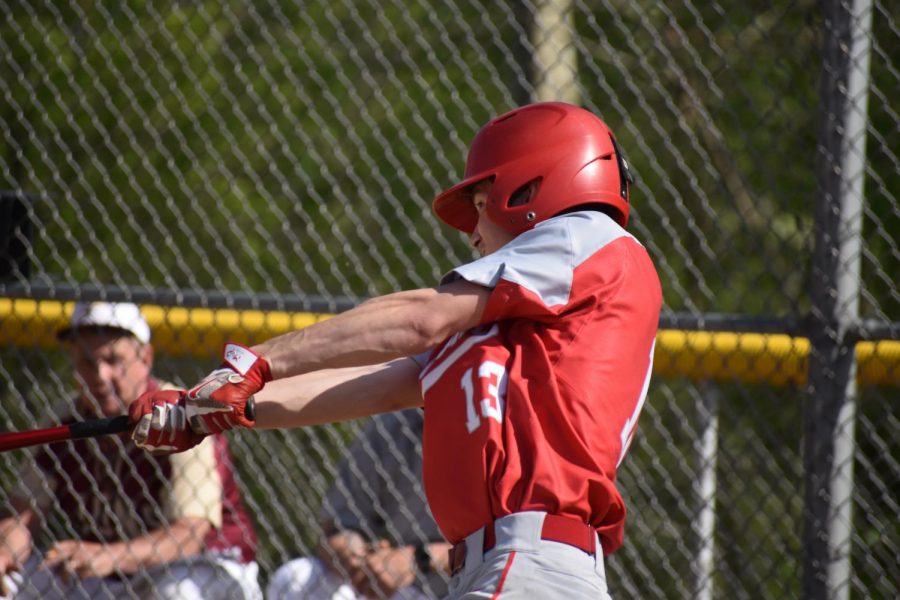 Sophomore Brett Boyd attempts to hit the ball in order to advance junior Jacob Bauman around the bases during the bottom of the second inning against New Brighton on May 6.