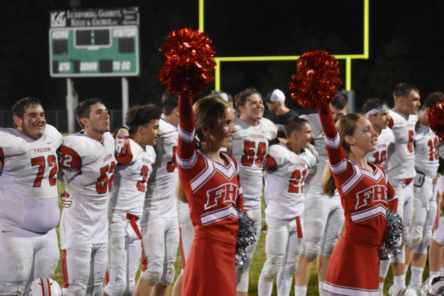 Cheerleaders strike a pose on the sidelines after the Bulldog’s victory at Riverside on Sept. 6.