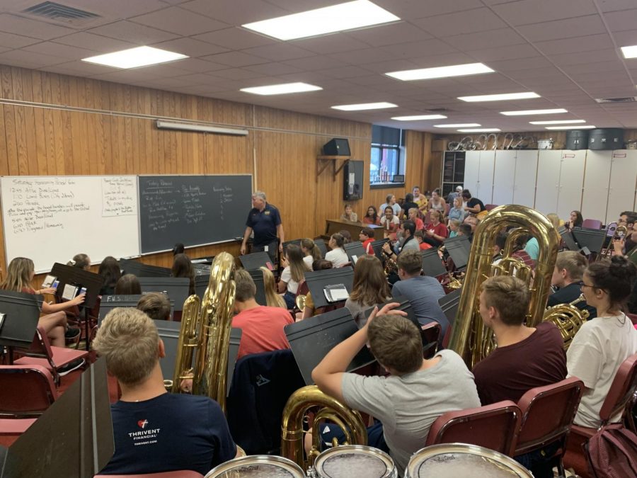 Band teacher, Robert James is updating the band class of upcoming events and new music they will be playing.
