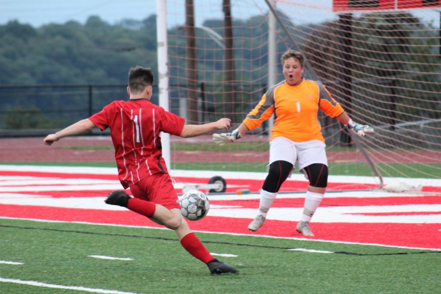 Senior Thomas Young gets ready to strike the ball to the left conner for another Freedom goal as Carlyton’s goalie charges out towards him. 