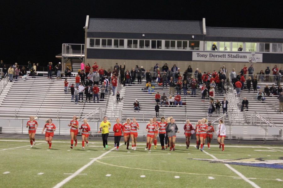 Following a tremendous 6-0 win over Bishop Canevin, the team runs over to the opposite sitline where the Freedom crowd is sitting as part of their celebration. After the crowd cheers them, they run back to their sidelines, excited by their win in the second round of playoffs.