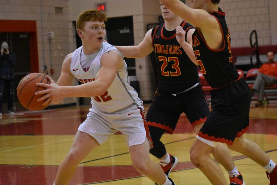 During a game last year against North Catholic, Senior Maxwell Ujhazy attempts to pass the ball to a teammate while being blocked by two defenders.