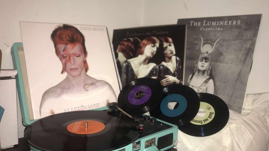 The albums, “Cleopatra” by The Lumineers, “Aladdin Sane” by David Bowie and “Ceremonials” by Florence + the Machine are displayed behind Myah Hrinko’s Crosley turntable. 
