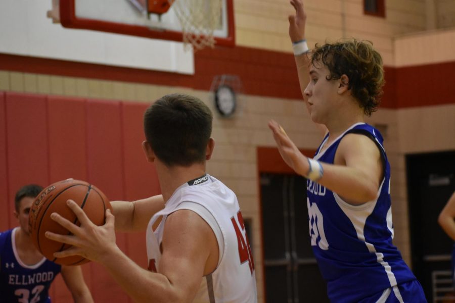 Senior Casey Collins keeps the ball away from the opposing team and looks to pass the ball at varsity’s first home game on Dec. 9. 