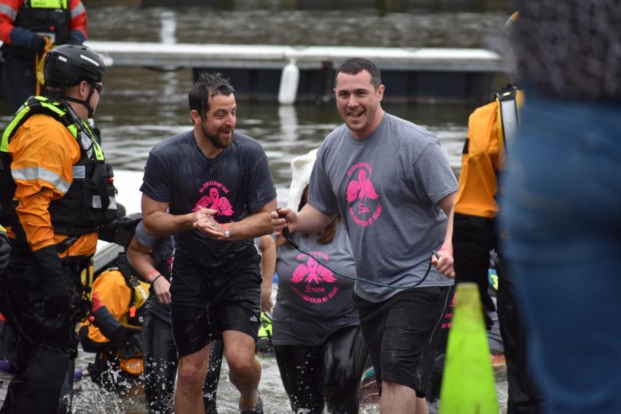 Middle school principal Ryan Smith and high school assistant principal Steven Mott smile as they walk out of the Ohio River.