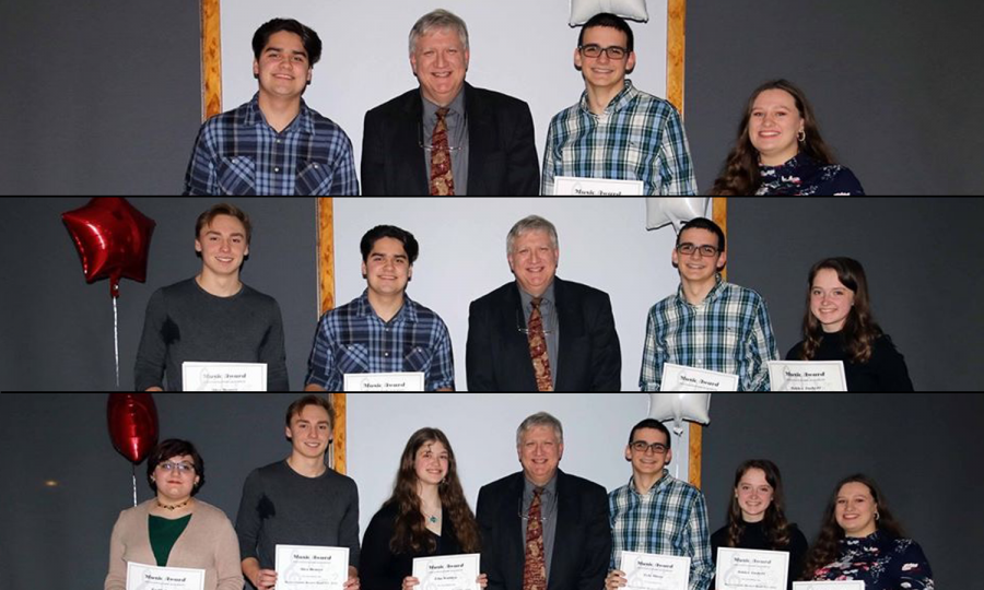 Mr. James stands with his students who were given awards for their band achievements during the band banquet.